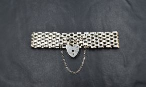 A 20th century silver gate link bracelet with heart padlock clasp and safety chain, marks for London