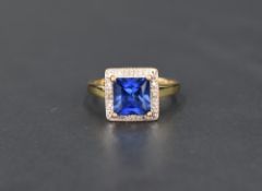 A princess cut tanzanite ring, stone approx 1.5ct, with a 4 diamond chip set illusionary set