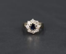 A sapphire and diamond cluster ring, approx 0.5ct diamonds & 0.5ct sapphire, all in a claw set