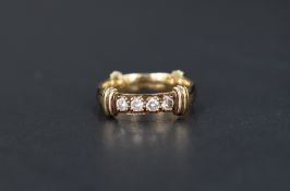 A 9ct gold wedding band having reided bands at four quarters and a four diamond inset, total