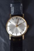 A 9ct gold Longines wristwatch, the champagne dial with baton five minute markers, the case having a