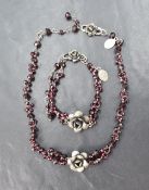 A rough cut garnet necklace and matching bracelet by Yvonne Christa of New York, both having central