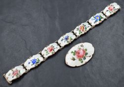 A silver guilloche enamel floral oval brooch depicting a rose, sold along with a matching