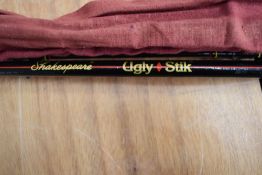 An Abu Garcia Conolon 1000 carbon 11ft 2pc spinning rod and a Shakespeare Ugly stick 2pc 7ft 2in
