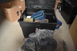 A black fishing box seat with a witchwood fishing bag containing some rod sleeves empty reel boxes