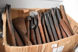 A box containing 22 stripped shotgun and rifle stocks