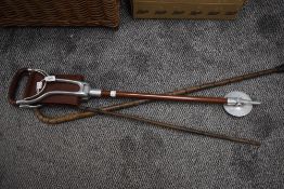 2 sticks and a leather seated shooting stick