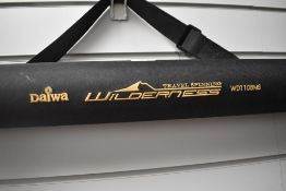 A Daiwa wilderness 6pc 11ft spinning rod in original soft sleeve and hard travel case