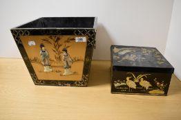 A Japanese lacquered box or trug, having handles to sides, painted decoration and raised composite