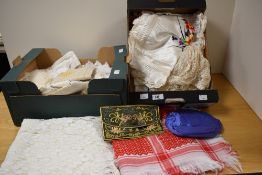 A small carton of linen tablecloths some having embroidery, two satin embroidered pillow shams and
