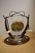 A Victorian silver plate and horn dinner gong, mounted upon an oval oak base, measuring 40cm high