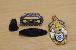 An assortment of costume items comprising a Masonic Institution Steward badge, a carved black