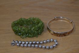 A selection of bracelets comprising a silver beaded example, a Chinese style expanding bracelet with