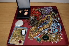 A large assortment of costume jewellery including beaded necklaces, a cameo set comprising of a