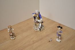 A 19th century Meissen hand-painted porcelain figure of a seated noble boy reading, relaxed pose