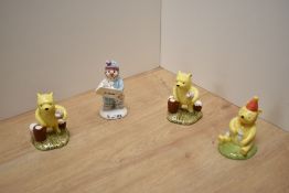 A group of three Royal Doulton bone china Disney Winnie The Pooh figures, Pooh Counting The Honey