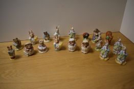 A collection of sixteen Royal Albert and two Beswick Pottery Beatrix Potter figures, to include