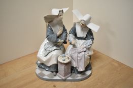 A Large Lladro porcelain figure group 'Nun's Sewing Circle' number 5360, formed as two seated nuns