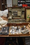 An oak marquetry decorated canteen of cutlery and an assorted selection of plated flatware and