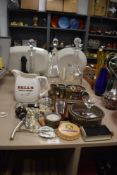 A collection of vintage bar accessories including three glass decanters, measures, bottle openers,