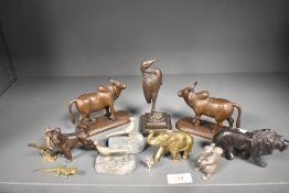 A 19th/20th Century bronze study of a heron on stepped base, measuring 15cm high, a pair of white