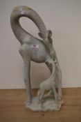 A carved African yellow granite study of a giraffe with calf.