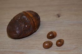 A carved Coquilla nut pomander / thimble holder, having floral decoration.