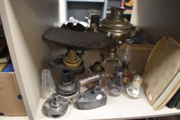 A mixed lot of vintage brass weighing scales, samovar, flat iron and various oil lamp parts.