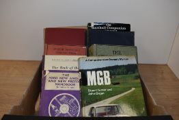 A small carton of classic car related books.