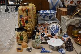 A collection of Oriental items including vases, bowls, mudmen and Buddha's etc.