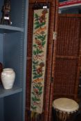 A 20th Century embroidered tapestry, illustrated with foxes and pheasants, mounted on a wrought