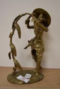 A 20th Century gilt metal study of an African man cutting corn, measuring 18cm tall