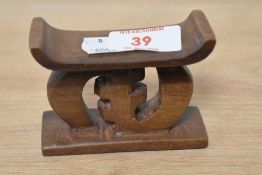 A miniture carved hardwood Ashanti stool.