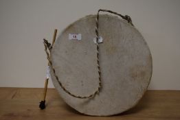 An African / Nigerian animal skinned drum, with drumstick.