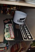 A quantity of advertising bar drip mats and an advertising ice bucket.