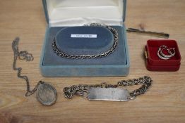 A collection of silver and white metal jewellery including a silver identity bracelet engraved