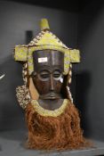 A central African carved wood, bead, shell and grass ornamented Lele (Democratic Republic of
