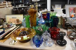 A selection of vintage glass in various colours including decanter and vases.