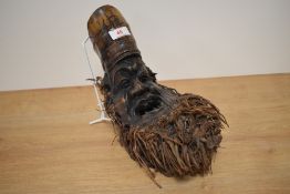 A 20th century Chinese carved bamboo root, depicting grotesque male, with inscription to head