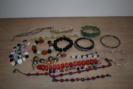 An assortment of costume bracelets including beaded examples, cuff bracelets and bangles etc.