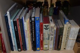 A collection of books, including war, coin and pigeon interest.