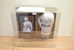 A framed RBK Boxing Glove bearing siganature from Amir Khan with photograph and COA