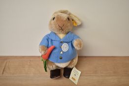 A modern Steiff Bear, 660481 Peter Rabbit with yellow tag and button, in pull string bag