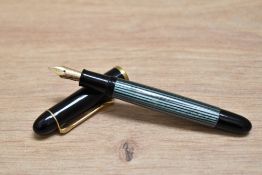 A Pelikan M140 twist fill fountain pen in green and black having Pelikan 14C 585 M nib