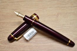 A boxed Sailor Promenade converter fill fountain pen in shining purple having a 1911 14K 585