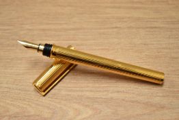 A boxed S T Dupont Montparnasse converter fountain pen gold plated reeded design having 18k Dupont