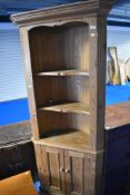 A natural pine corner shelf with cupboard under, height approx. 191cm