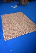 A modern rug, in the pegged style , shades of cream , orange and red, approx. 230 x 170cm