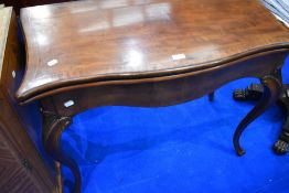 An Edwardian mahogany fold over card table on shaped legs, width approx. 91
