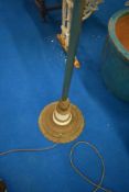 A vintage brass standard lamp